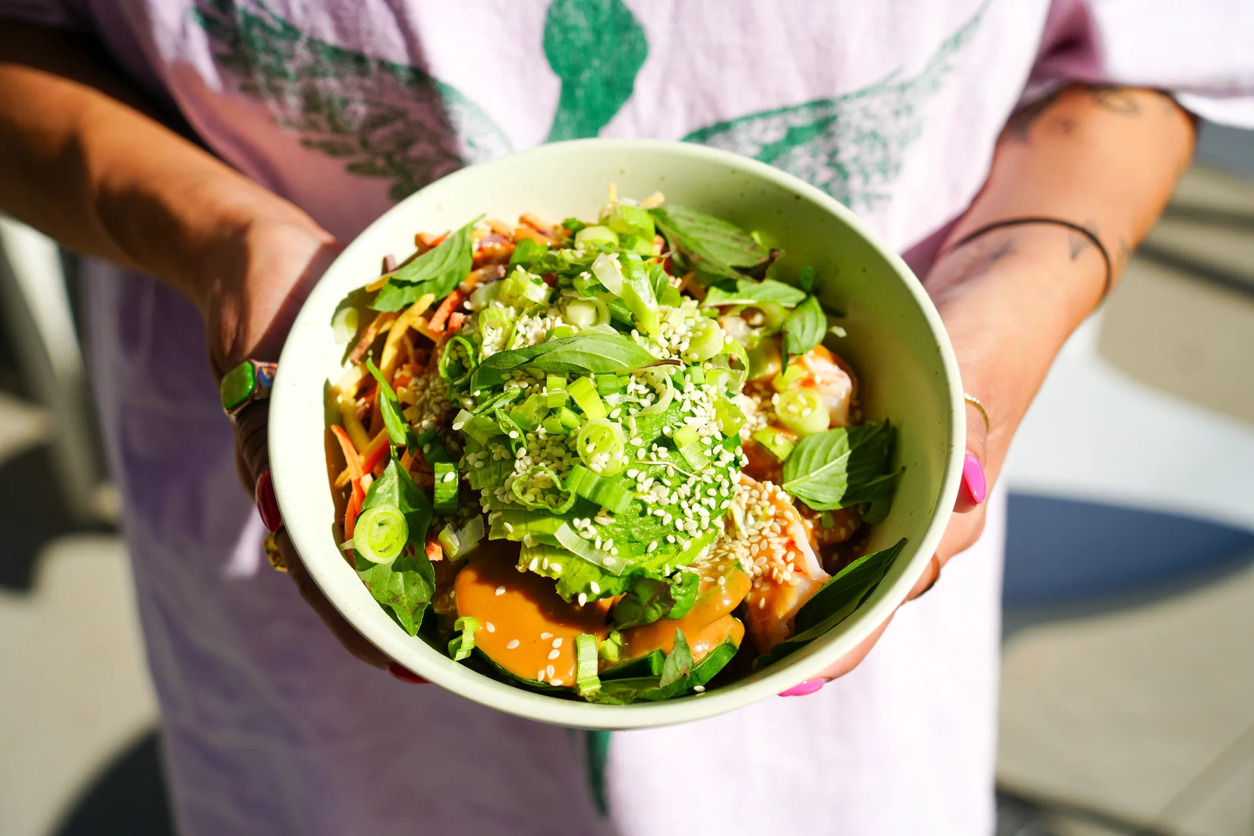 Colorful grain bowl held in both hands